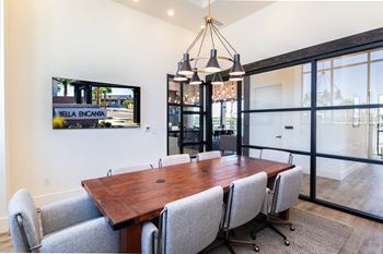 a conference room with a wooden table and chairs